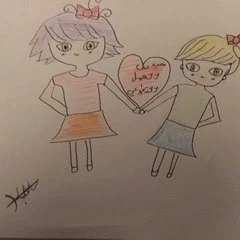 Children's crayon drawing of two girls holding hands with a heart, from an ABA4Change outreach camp