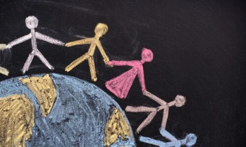 Chalk drawing of stick figures holding hands in a chain, standing on a globe, representing community support